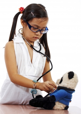 child playing doctor with teddy.jpg child playing doctor with teddy.jpg